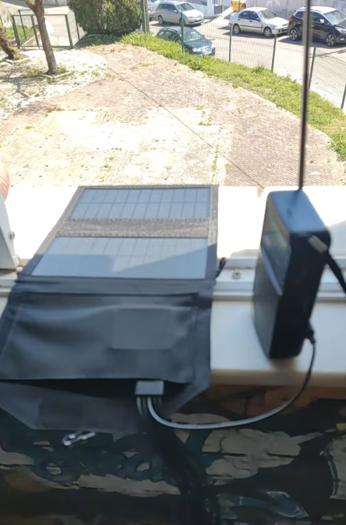 Panel solar cargando dispositivo en ventana